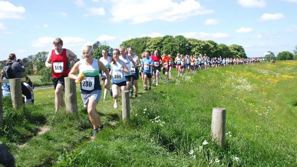 Runners along the riverbank path at the Riverbank Challenge